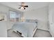 Bright bedroom with ceiling fan, and a large window view at 9538 W San Juan Cir # 104, Littleton, CO 80128