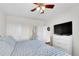 Bright bedroom boasts ceiling fan, TV, and access to bathroom at 9538 W San Juan Cir # 104, Littleton, CO 80128