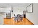 Bright dining area features hardwood floors, modern lighting, and a neutral color scheme at 9538 W San Juan Cir # 104, Littleton, CO 80128