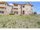 Condominium exterior boasting stone accents, balconies, and manicured landscaping at 9538 W San Juan Cir # 104, Littleton, CO 80128