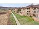Exterior view of townhomes, boasting stone accents, balconies, and well-maintained landscaping at 9538 W San Juan Cir # 104, Littleton, CO 80128
