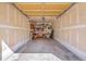 Spacious empty garage features ample space and shelving for organization and storage at 9538 W San Juan Cir # 104, Littleton, CO 80128