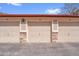 Exterior shot of multiple car garages featuring individual unit numbers, classic lighting, and stone pillars at 9538 W San Juan Cir # 104, Littleton, CO 80128
