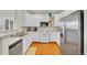 Kitchen boasts modern appliances, white cabinetry, and hardwood floors at 9538 W San Juan Cir # 104, Littleton, CO 80128