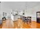 Open concept living space featuring hardwood floors, updated kitchen, and dining area at 9538 W San Juan Cir # 104, Littleton, CO 80128