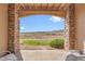 Outdoor patio with brick columns features seating and a scenic view of the open fields and distant mountains at 9538 W San Juan Cir # 104, Littleton, CO 80128