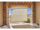 Covered patio with shades, brick columns and seating features a scenic view of the open fields and distant mountains at 9538 W San Juan Cir # 104, Littleton, CO 80128