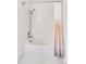 Bright shower boasts tiled walls and curtain at 9538 W San Juan Cir # 104, Littleton, CO 80128
