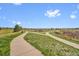 Scenic walking path winds through lush green spaces, inviting residents to embrace an active outdoor lifestyle at 9538 W San Juan Cir # 104, Littleton, CO 80128