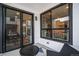 Outdoor balcony featuring a view through sliding glass doors into a well-lit dining space at 2036 S Holly St # 1, Denver, CO 80222