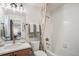 Bright bathroom featuring a shower-tub combination and neutral-toned decor for a modern look at 2036 S Holly St # 1, Denver, CO 80222