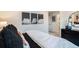 Cozy bedroom featuring cloud artwork, a dark dresser, and carpeted floors at 2036 S Holly St # 1, Denver, CO 80222