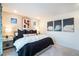 Primary bedroom with large window, unique artwork, side tables, and plush bedding at 2036 S Holly St # 1, Denver, CO 80222