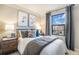 Bright bedroom with side tables and grey bedding at 2036 S Holly St # 1, Denver, CO 80222