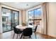 Stylish dining area with large windows and a sliding glass door offering views at 2036 S Holly St # 1, Denver, CO 80222