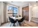 Charming dining area with a round marble table and large window providing natural light at 2036 S Holly St # 1, Denver, CO 80222