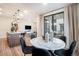 Open dining area adjacent to kitchen, featuring modern lighting and outdoor views at 2036 S Holly St # 1, Denver, CO 80222