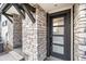 Stylish front entrance showcasing a modern door with glass panels and attractive stone accents at 2036 S Holly St # 1, Denver, CO 80222