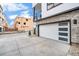 Attached garage with modern door design, providing secure parking and storage space at 2036 S Holly St # 1, Denver, CO 80222