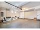 Clean garage providing lots of open space, with a garage door and a separate white door at 2036 S Holly St # 1, Denver, CO 80222