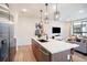 Modern kitchen with a large island, stainless steel appliances, and open layout to the living room at 2036 S Holly St # 1, Denver, CO 80222