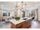 Bright kitchen boasts a spacious island, modern pendants, and open sightlines to living areas at 2036 S Holly St # 1, Denver, CO 80222