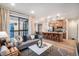 Open-concept living room flows into the kitchen with a large window and contemporary furnishings at 2036 S Holly St # 1, Denver, CO 80222