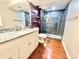 Bathroom with granite vanity and updated shower at 8590 Faraday St, Denver, CO 80229
