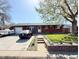 Charming brick home featuring a manicured lawn and driveway with ample parking at 8590 Faraday St, Denver, CO 80229