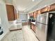 Well-lit kitchen with stainless steel appliances, tile flooring, and spacious countertops at 8590 Faraday St, Denver, CO 80229