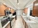 Well-equipped kitchen featuring stainless steel appliances, tile floors and ample counter space at 8590 Faraday St, Denver, CO 80229