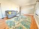 Cozy living room featuring hardwood floors, area rug, and comfortable sofa at 8590 Faraday St, Denver, CO 80229