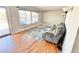 Bright living room with hardwood floors, large windows, and comfortable seating at 8590 Faraday St, Denver, CO 80229