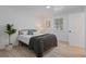 This bedroom features a comfortable bed, light-colored flooring, and a window that fills the space with natural light at 7830 Ladore St, Commerce City, CO 80022