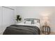 Cozy bedroom featuring a comfortable bed with stylish gray bedding and a modern side table at 7830 Ladore St, Commerce City, CO 80022