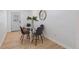 Bright dining area features modern chairs, a glass table, and a stylish mirror creating an inviting space for meals at 7830 Ladore St, Commerce City, CO 80022