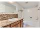 Bathroom featuring granite countertops, a white vanity, and a combined bathtub and shower at 9837 E Peakview Ave # 7, Englewood, CO 80111