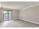 Bright bedroom featuring light gray wood floors and sliding glass doors leading to a balcony at 9837 E Peakview Ave # 7, Englewood, CO 80111