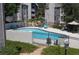 A community outdoor swimming pool area is enclosed by a black iron fence at 9837 E Peakview Ave # 7, Englewood, CO 80111