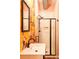 A trendy bathroom offers unique wallpaper, a framed mirror and a walk-in shower at 117 Elati St # 1, Denver, CO 80223