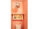 A half-bathroom features fun and quirky wallpaper, a disco ball, and a cute storage cabinet at 117 Elati St # 1, Denver, CO 80223