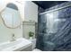 Charming bathroom featuring elegant finishes, a unique mirror, and a stylish tiled shower at 117 Elati St # 1, Denver, CO 80223