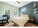 Relax in the bedroom that features great natural light, art, and plenty of space at 117 Elati St # 1, Denver, CO 80223