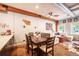 Open-concept dining area featuring exposed brick, wood accents, and seamless integration with living room at 117 Elati St # 1, Denver, CO 80223