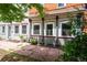 Side view of the home showing garden beds and a paved walkway, highlighting the property's curb appeal at 117 Elati St # 1, Denver, CO 80223