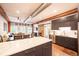 Open-concept kitchen features modern cabinetry, stainless appliances, a large island, and exposed ductwork at 117 Elati St # 1, Denver, CO 80223