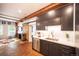 Stylish kitchen with modern cabinetry, stainless steel appliances, quartz countertops, and exposed wood beams at 117 Elati St # 1, Denver, CO 80223