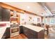 Modern kitchen with stainless steel appliances, white countertops, gray cabinetry, dining table and exposed beams at 117 Elati St # 1, Denver, CO 80223