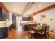 Bright kitchen with gray cabinets, stainless steel appliances, a dining table, and concrete floors at 117 Elati St # 1, Denver, CO 80223