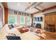 Bright living room with a comfortable sectional, wood beams, concrete floors, and entertainment setup at 117 Elati St # 1, Denver, CO 80223